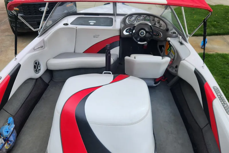 Slide: The Image of Interior of a 2006 Correct Craft 196 boat with red and white seating. - 2