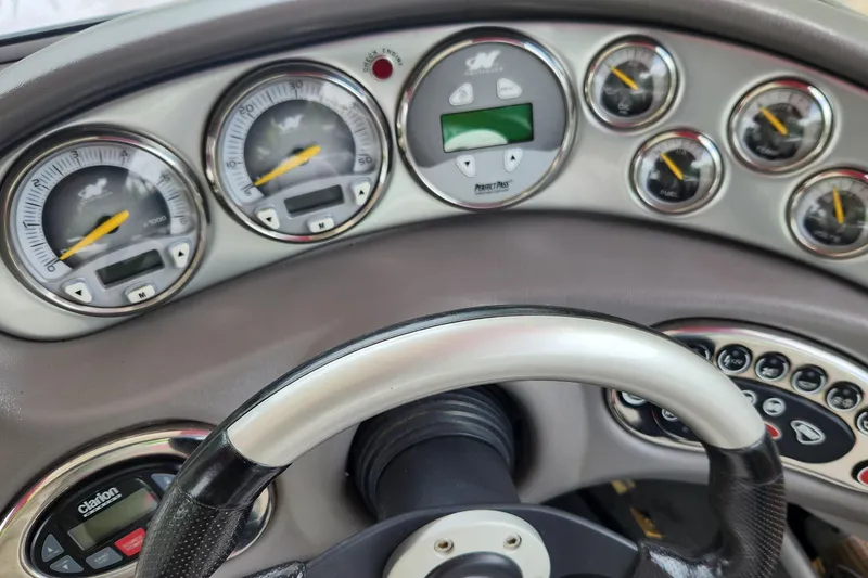 Slide: The Image of Dashboard of a 2006 Correct Craft 196 boat with gauges and controls. - 4