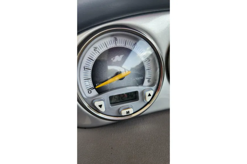 Slide: The Image of Close-up of a 2006 Correct Craft 196 boat tachometer displaying 572 hours. - 5