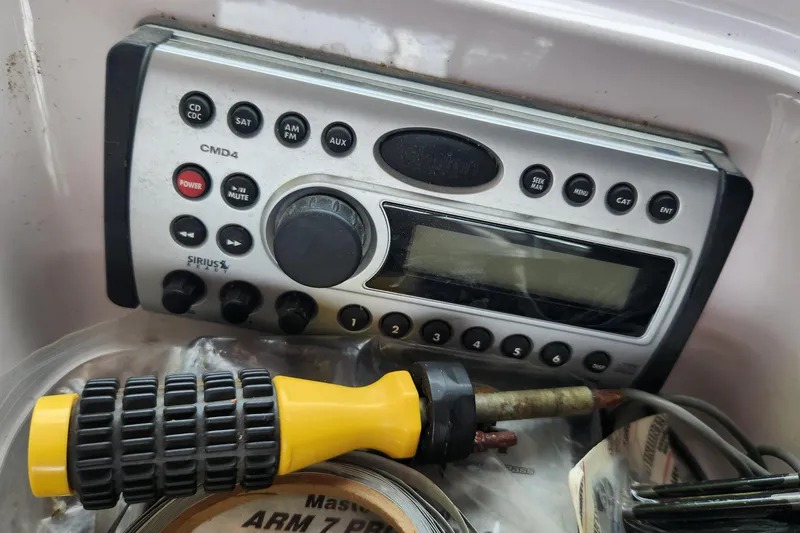 Slide: The Image of 2006 Correct Craft 196 boat radio system with screwdriver and tools nearby. - 7