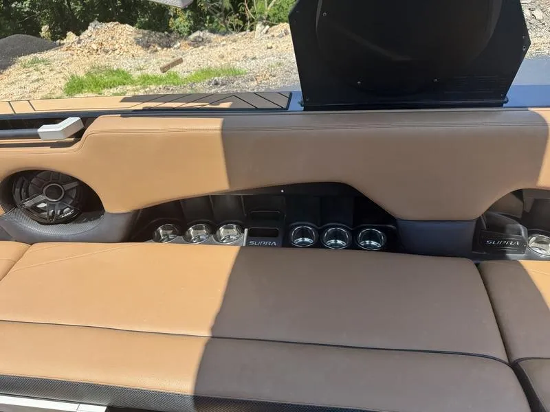 Slide: The Image of 2020 Supra 450 SE interior with tan leather seats and built-in cup holders. - 13