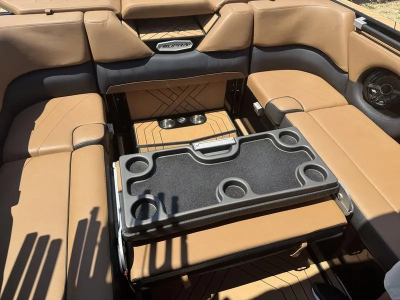 Slide: The Image of 2020 Supra 450 SE interior with tan leather seats and cup holders. - 15