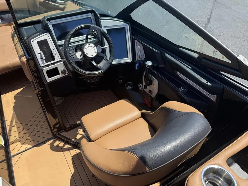 Slide: The Image of 2020 Supra 450 SE boat interior with modern dashboard and tan leather seating. - 3