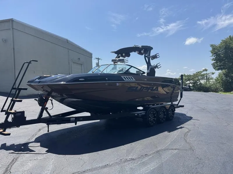 Slide: The Image of 2020 Supra 450 SE boat on trailer in parking lot under clear sky. - 6
