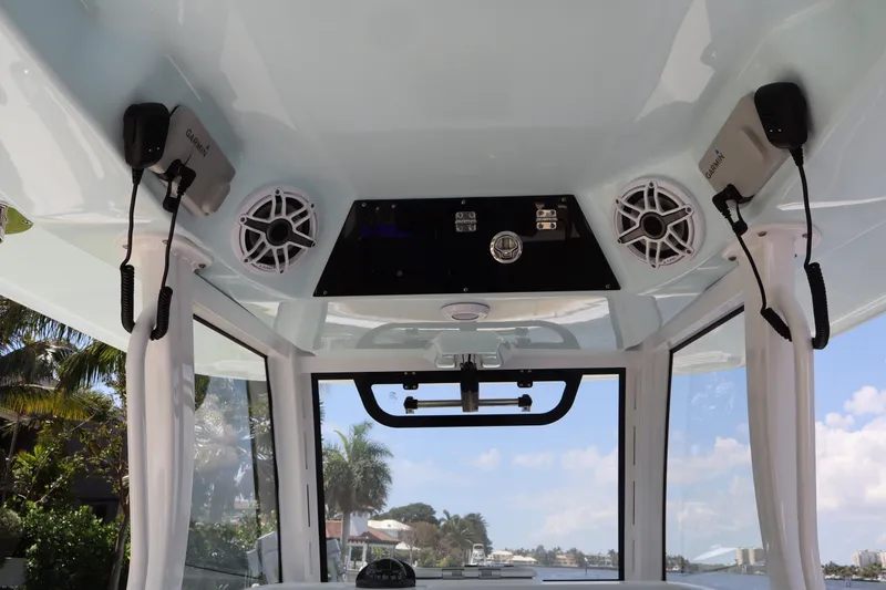 Slide: The Image of 2025 Sportsman Open 322 Center Console interior with speakers and Garmin devices. - 11