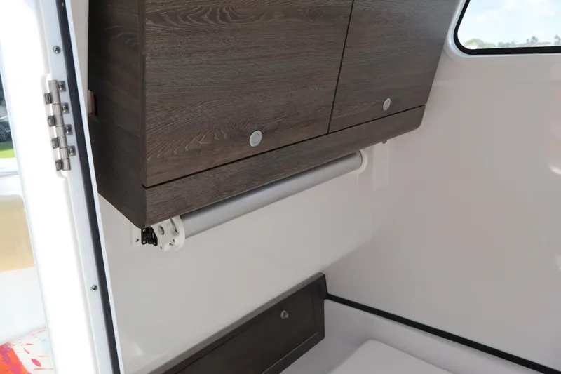 Slide: The Image of Interior of 2025 Sportsman Open 322 Center Console with wooden cabinetry. - 15