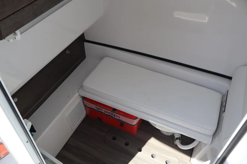 Slide: The Image of 2025 Sportsman Open 322 Center Console interior with bench, life jackets, and storage. - 16