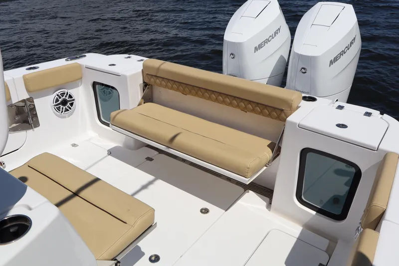 Slide: The Image of 2025 Sportsman Open 322 Center Console boat with beige seating and twin Mercury engines. - 19