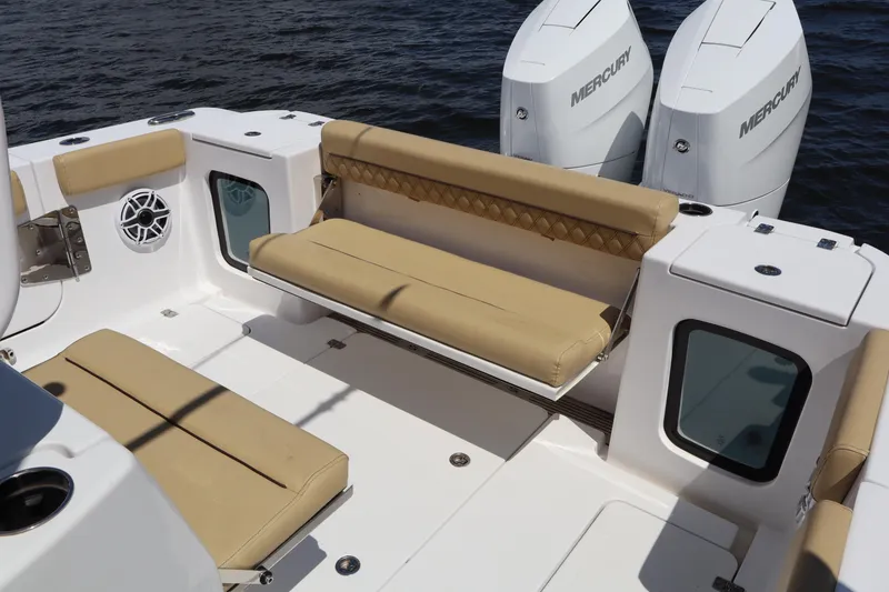 Slide: The Image of 2025 Sportsman Open 322 Center Console boat with tan seating and dual Mercury engines. - 20