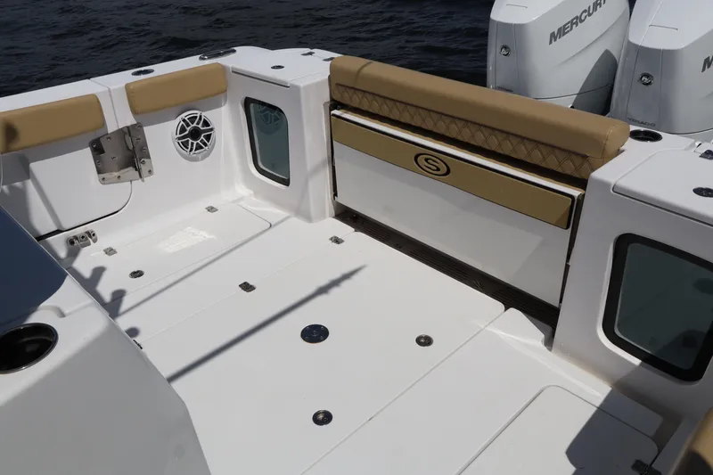 Slide: The Image of 2025 Sportsman Open 322 Center Console boat interior with tan seating and Mercury engines. - 21