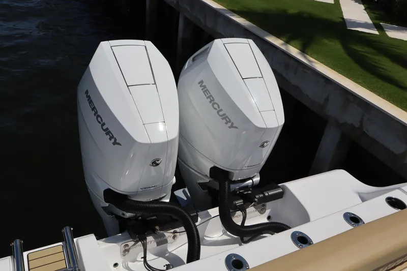 Slide: The Image of Twin Mercury outboard engines on a 2025 Sportsman Open 322 Center Console boat. - 22