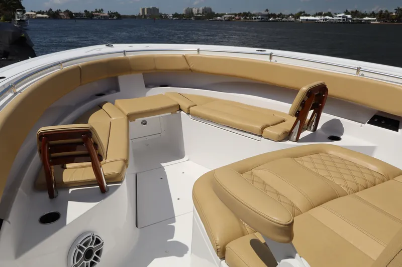 Slide: The Image of Luxurious seating on 2025 Sportsman Open 322 Center Console boat, docked by the water. - 7
