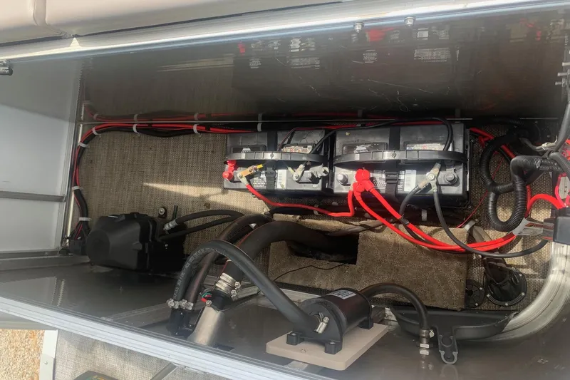 Slide: The Image of Battery compartment of a 2015 Avalon Windjammer Elite 25' boat with wiring and components. - 15