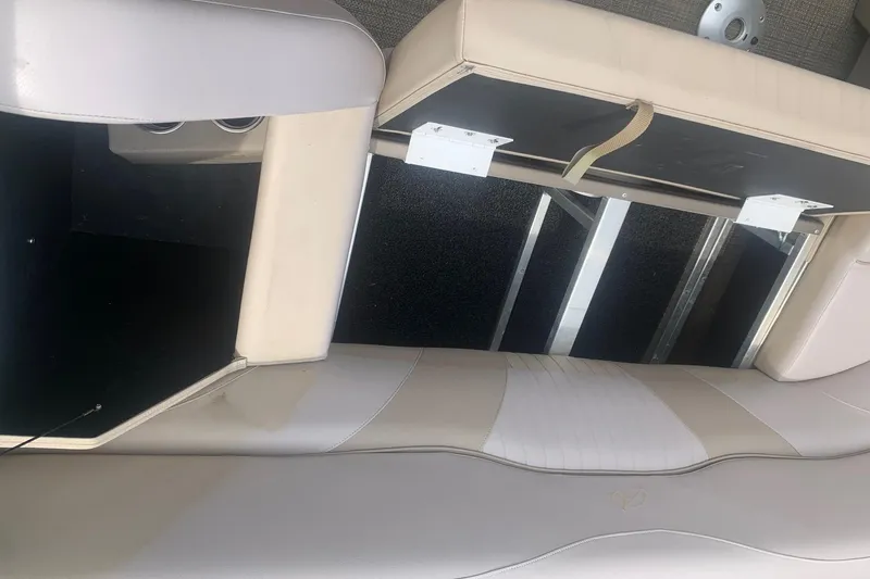 Slide: The Image of Interior seating of 2015 Avalon Windjammer Elite 25' boat, showcasing storage compartment. - 16