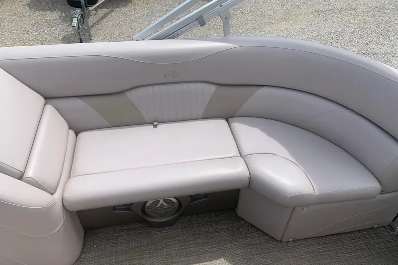 Slide: The Image of 2015 Avalon Windjammer Elite 25' boat interior with plush seating and integrated speaker. - 5