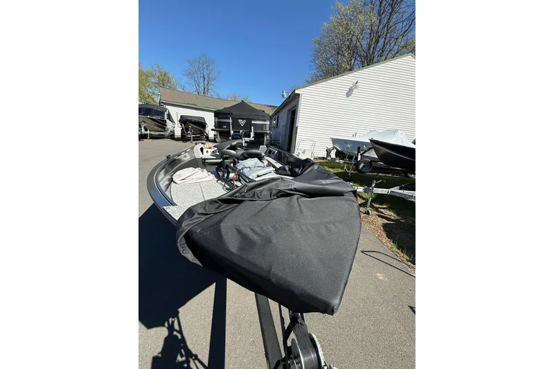 Slide: The Image of 2020 MirroCraft 1415 Outfitter boat with cover, parked outdoors on a sunny day. - 5