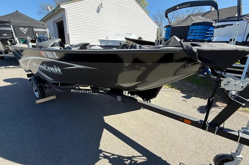 Slide: The Image of 2020 MirroCraft 1415 Outfitter boat on trailer, parked outdoors in sunlight. - 7