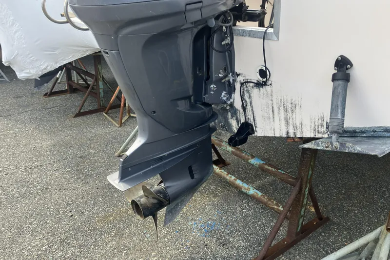 Slide: The Image of 1998 Grady-White Seafarer 226 boat with outboard motor on a stand. - 11