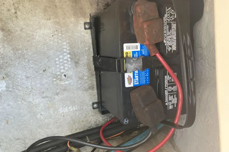 Slide: The Image of Battery compartment of a 1998 Grady-White Seafarer 226 boat with cables connected. - 15