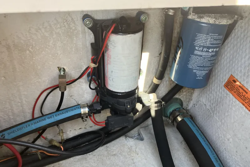 Slide: The Image of 1998 Grady-White Seafarer 226 boat engine compartment with marine hoses and filters. - 16