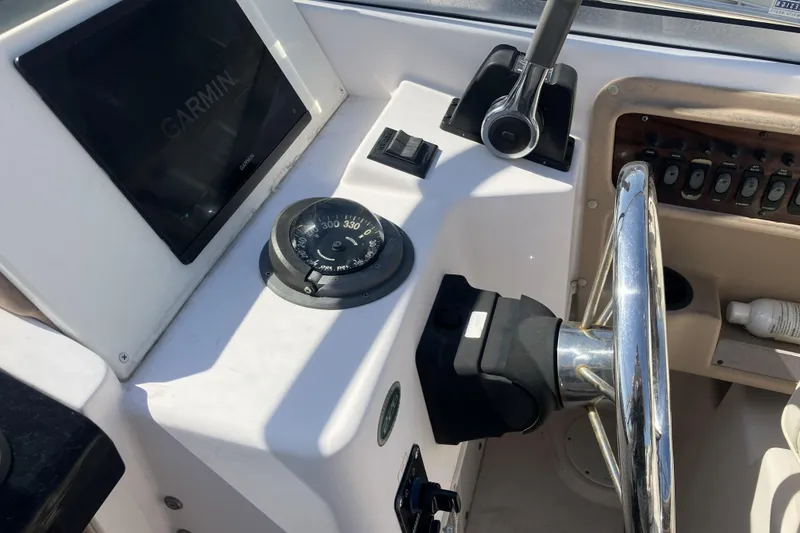 Slide: The Image of Grady-White Seafarer 226 boat dashboard with Garmin display and compass, 1998 model. - 20