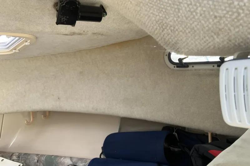 Slide: The Image of Interior cabin of a 1998 Grady-White Seafarer 226 boat, featuring upholstery and window details. - 28