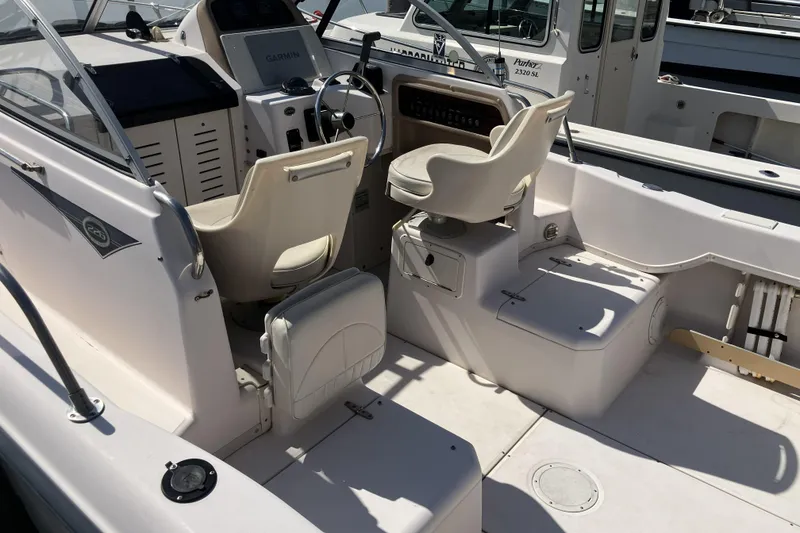 Slide: The Image of 1998 Grady-White Seafarer 226 boat interior with helm and seating area. - 4