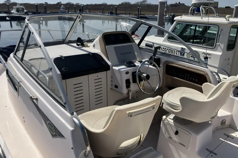 Slide: The Image of 1998 Grady-White Seafarer 226 boat interior with steering wheel and seating. - 5