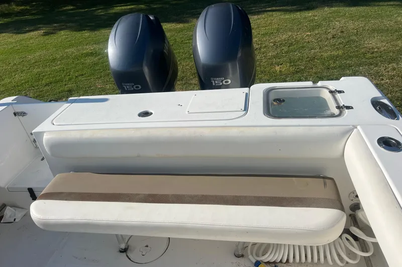 Slide: The Image of 2012 Sea Hunt Gamefish 27 boat with Yamaha 150 engines, featuring a cushioned bench seat. - 4