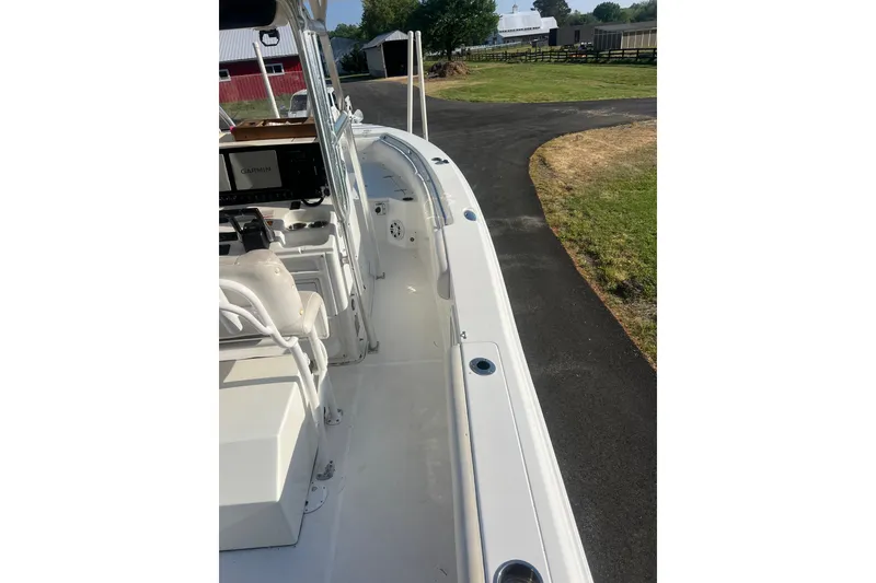 Slide: The Image of 2012 Sea Hunt Gamefish 27 boat interior with Garmin navigation system, parked on a driveway. - 5