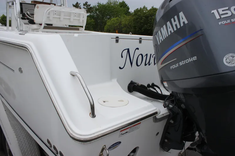 Slide: The Image of 2012 Sea Hunt Gamefish 27 boat interior with rod holders and storage compartment. - 18