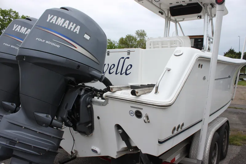 Slide: The Image of 2012 Sea Hunt Gamefish 27 boat interior with seating and dual Yamaha engines. - 19