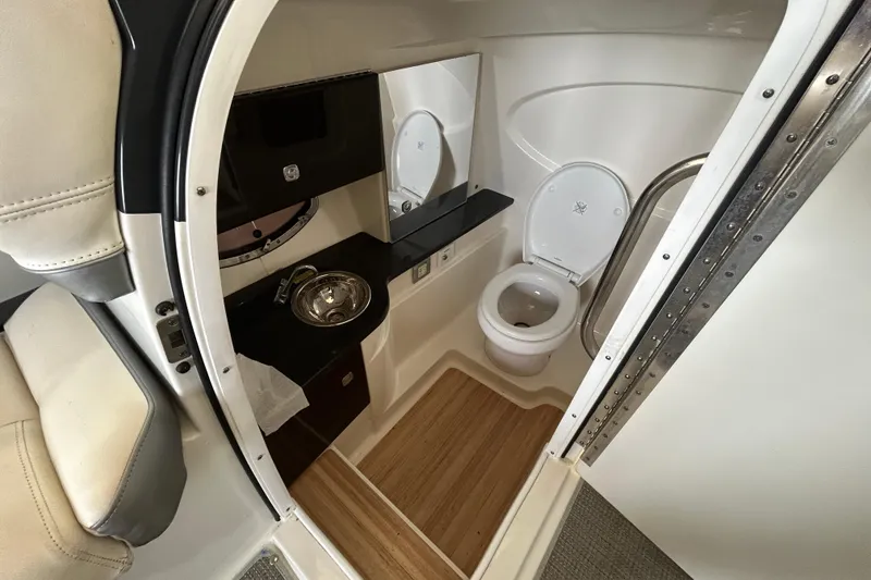 Slide: The Image of Interior of 2015 Formula 310 Bowrider boat bathroom with toilet and sink. - 10