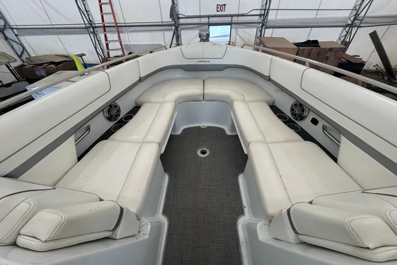 Slide: The Image of 2015 Formula 310 Bowrider interior with white seating and carpeted floor. - 11