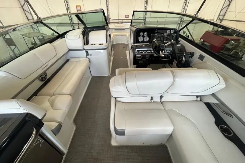 Slide: The Image of 2015 Formula 310 Bowrider interior with white seating and modern dashboard controls. - 6