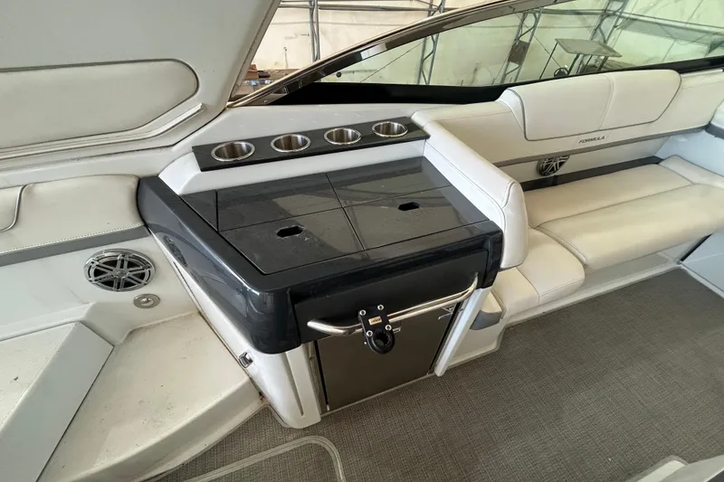 Slide: The Image of 2015 Formula 310 Bowrider interior with seating and cup holders. - 7