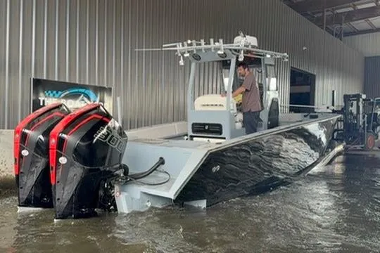 Slide: The Image of 2019 Metal Shark 28 CC boat with dual engines in a marina setting. - 10
