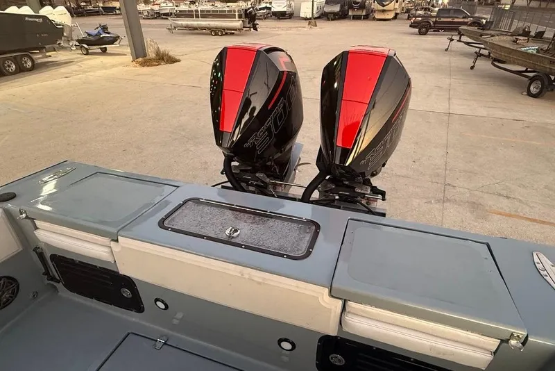 Slide: The Image of 2019 Metal Shark 28 CC boat with dual outboard motors in a marina setting. - 11