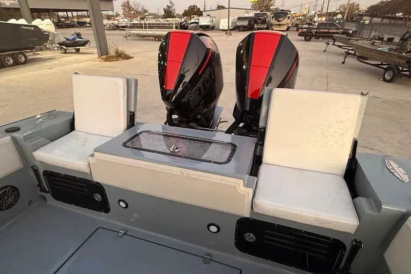 Slide: The Image of 2019 Metal Shark 28 CC boat with dual engines and seating in a marina setting. - 12