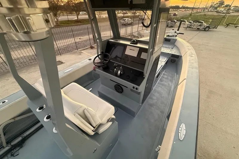 Slide: The Image of 2019 Metal Shark 28 CC boat interior with steering console and seating. - 16