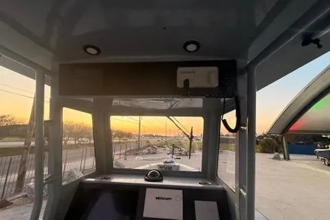 Slide: The Image of Interior view of a 2019 Metal Shark 28 CC boat at sunset. - 18