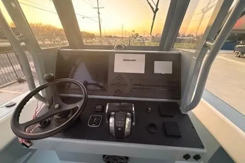 Slide: The Image of Control panel of a 2019 Metal Shark 28 CC boat at sunset. - 19