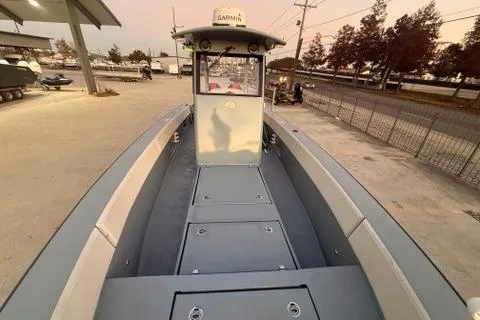 Slide: The Image of 2019 Metal Shark 28 CC boat docked, showcasing spacious deck and control console. - 23