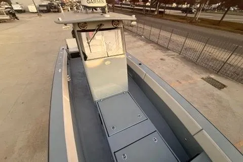 Slide: The Image of 2019 Metal Shark 28 CC boat with Garmin equipment, docked on a concrete surface. - 24
