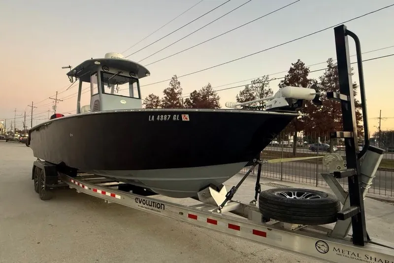Slide: The Image of 2019 Metal Shark 28 CC boat on trailer at sunset, parked on roadside. - 6