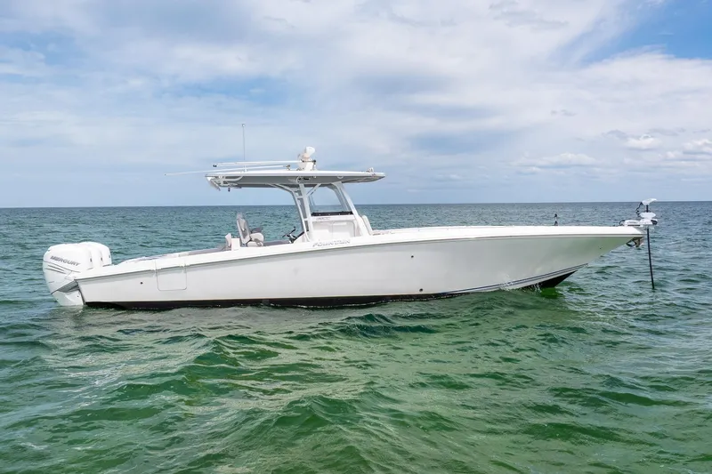 The Image of 2021 Fountain 38 Center Console boat on calm ocean waters under a cloudy sky. - 0