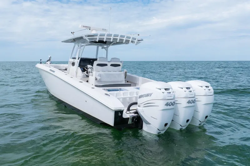 The Image of 2021 Fountain 38 Center Console boat with triple Mercury 400 engines on open water. - 1