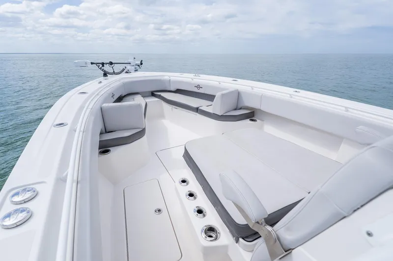 Slide: The Image of 2021 Fountain 38 Center Console boat interior with cushioned seating on open water. - 10