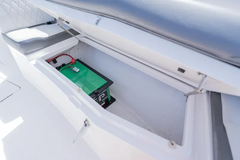 Slide: The Image of 2021 Fountain 38 Center Console boat battery compartment with green battery inside. - 16