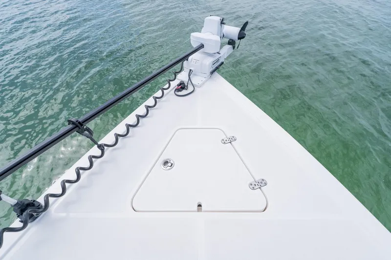 Slide: The Image of Bow of 2021 Fountain 38 Center Console boat with trolling motor on calm water. - 18